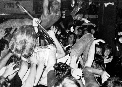artists crowd surfing in a black and white photo